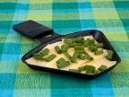 Raclette pan with cheese and spring onion - party food