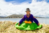Sitting girl on a floating Uros island, Titicaca